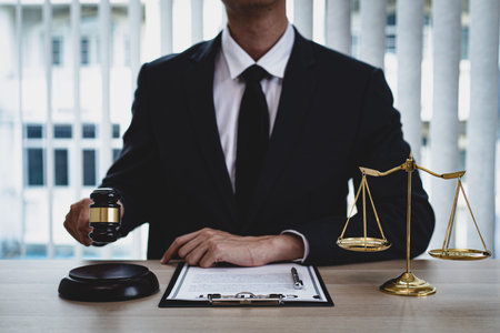 Judge or a lawyer works documents in the courtroom and analyze the various laws for justice and...