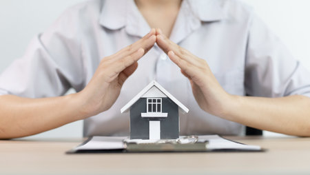 Real estate agent or sales manager has proposed terms and conditions to customers who sign house purchase agreements with insurance, Agreement to sign the purchase contract concept.の写真素材