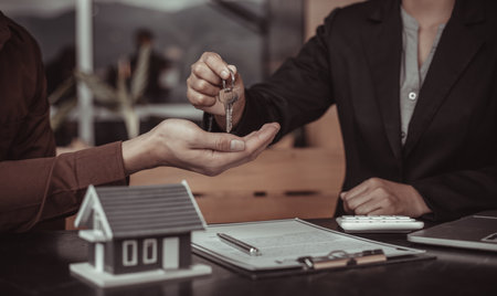 Real estate agent or sales manager has offered home sales and explained the terms of signing the house purchase contract and free home insurance, Finance and after-sales service concept.の写真素材