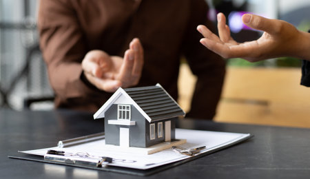 Real estate agent or sales manager has offered home sales and explained the terms of signing the house purchase contract and free home insurance, Finance and after-sales service concept.の写真素材