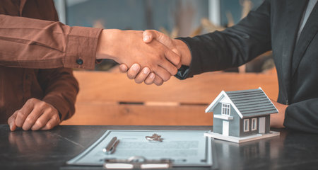 Real estate agents and customers shake hands to congratulate on signing a contract to buy a house with land and insurance, handshake and Good response concept.の写真素材