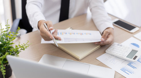 Financial businessmen analyze the graph of the company's performance to create profits and growth, Market research reports and income statistics, Financial and Accounting concept.の写真素材