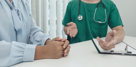 Specialist doctors advise and examine the history of patients in a direct health room at a modern hospital, Annual Health Check and Health Care Report concept.の写真素材