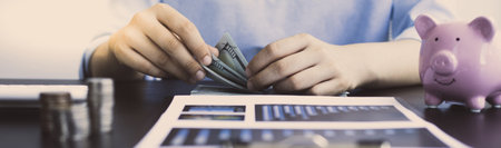 Counting money, businessmen have analyzed between cash and credit card which is consistent and convenient to spend in the present day.の写真素材