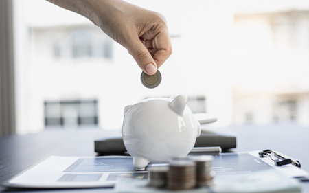 Young woman is saving money and calculating the income and expenses of the house due to the poor...