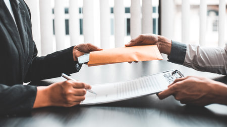 Businessmen give dollars to bribe employees in signing contracts to buy illegal land and real estate, Business fraud and social injustice, corruption and bribery concept.の写真素材