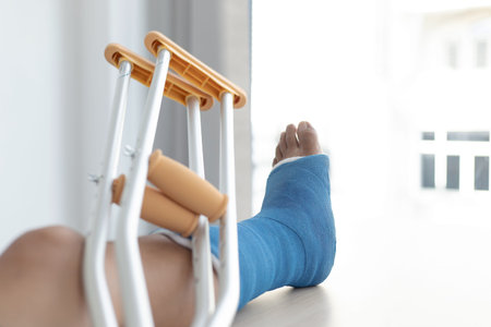 Blue ankle and foot splint Bandages on the legs from a young man's fall accident, Blue plaster on...