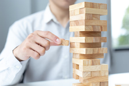 Business people play wooden games, divide the average investment value of a business and jointly manage risks, Alternative risk plan and strategy in business.の写真素材