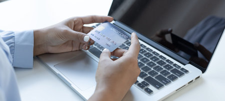 Women use laptop register via credit cards to make online purchases, Using the Internet in Online...