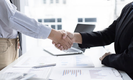 Financial accountants and marketers shaking hand to congratulate the double-digit real estate performance, Meetings and hand shake concept.の写真素材