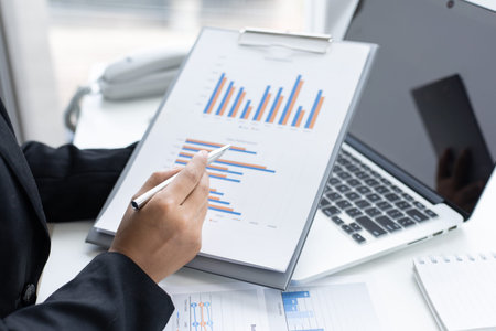 Financial businesswomen analyze the graph of the company's performance to create profits and growth,...