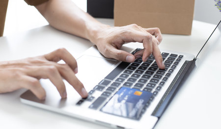 Men use laptop to register online purchases using credit card payments, Convenience in the world of technology and the internet, Shopping online and banking online concept.の写真素材