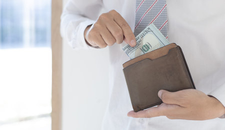 Young man took out the 100 dollar bill from the brown purse, Spending money with cash, Campaign to...