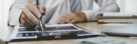 Male investment businessman has analyzed the market of the stock graph and evaluated the financial risks with the Business Intelligence Finance dashboard in a laptop, Stock market concept.の写真素材