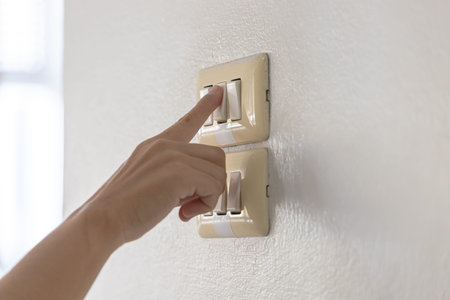 Close up young man's hand pressed the button to turn on the light switch, Open the electrical...