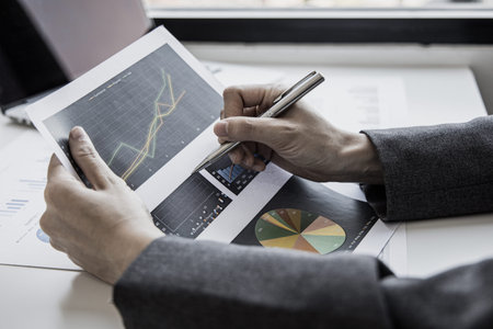 Financial businesswomen analyze the graph of the company's performance to create profits and growth,...