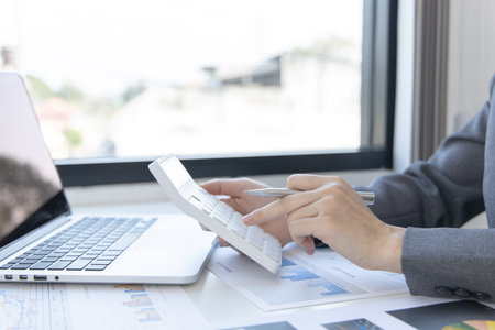 Accounting businesswomen are calculating income-expenditure and analyzing real estate investment...