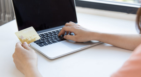 Online product purchase, Businesswoman use laptop register via credit cards to make online...