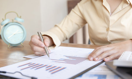 Financial businesswomen analyze the graph of the company's performance to create profits and growth,...