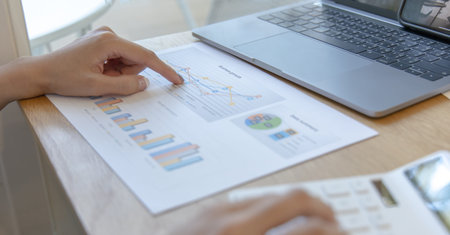 Financial businesswoman calculating corporate income tax data And analyzing charts of financial...