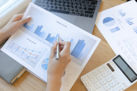 Financial businesswomen analyze the graph of the company's performance to create profits and growth, Market research reports and income statistics, Financial and Accounting concept.の写真素材