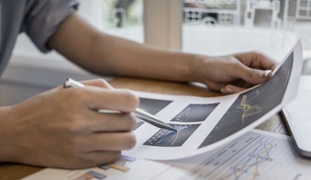 Financial businesswomen analyze the graph of the company's performance to create profits and growth, Market research reports and income statistics, Financial and Accounting concept.の写真素材