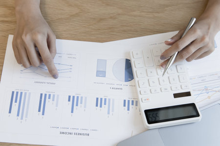 Financial businesswoman calculating corporate income tax data And analyzing charts of financial...