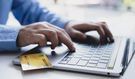 Online product purchase, Businessman use laptop register via credit cards to make online purchases,...