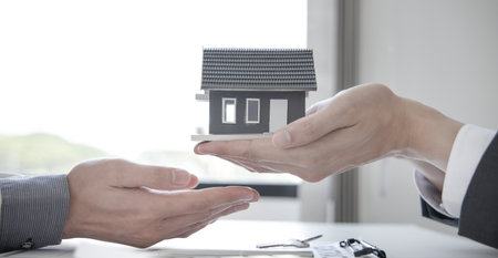 Real estate agent or sales manager has offered home sales and explained the terms of signing the house purchase contract and free home insurance, Finance and after-sales service concept.の写真素材