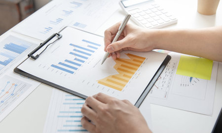 Financial businessman analyze the graph of the company's performance to create profits and growth,...