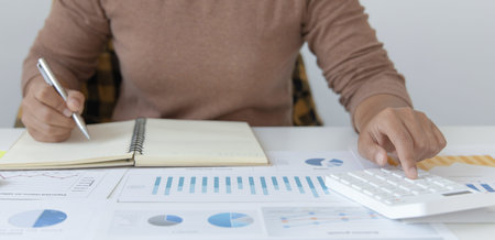 Head of accounting is recording the company's financial growth statistics using graphs as a...