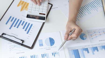 Financial businesswoman calculating corporate income tax data And analyzing charts of financial...