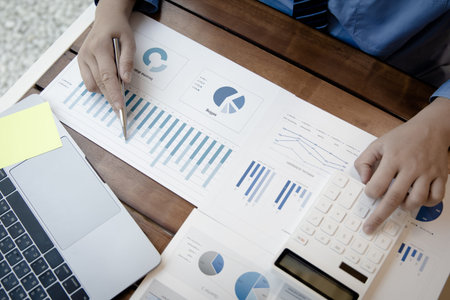 Financial businessmen analyze the graph of the company's performance to create profits and growth,...