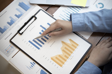 Financial businessmen analyze the graph of the company's performance to create profits and growth,...