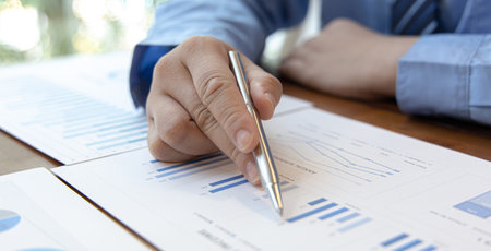 Financial businessmen analyze the graph of the company's performance to create profits and growth,...
