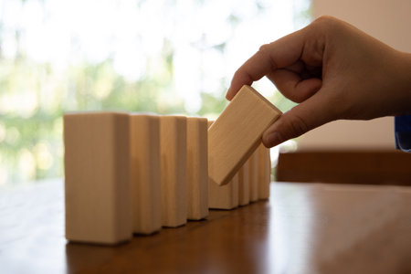 Strategies and risks of wooden games, Close-up of business people gambling with investment risk, Business people play wooden games to simulate planning and strategy for managing business risk.の写真素材