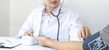 Female doctors use blood pressure monitors and stethoscope to measure pulse Diagnose the patient's...