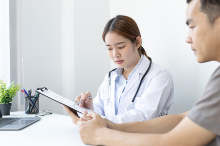 Doctor is currently diagnosing the disease and giving advice to psychiatric patients, Checking the history and medical conditions in a clinic or hospital, Health care counseling.の写真素材