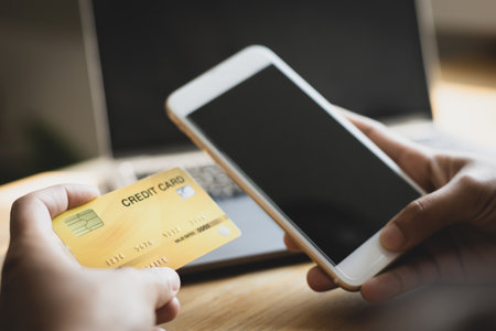 Women use smart phone to register online purchases using credit card payments, Technology for the use of smartphones for business or online financial transactions, Shopping online and banking online concept.の写真素材
