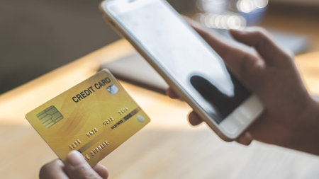 Women use smart phone to register online purchases using credit card payments, Technology for the...