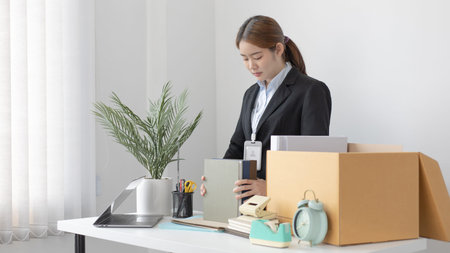 Put the work equipment in the office in a large brown box, Businessmen are keeping work documents...