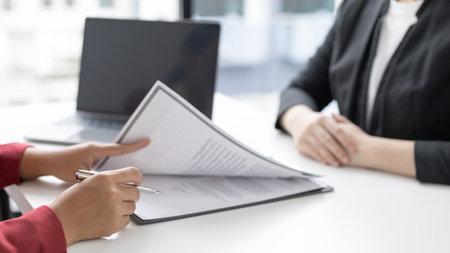 Employer or HR department is reading the resume and interviewing the ability of new employees, Employer is selecting job applicants, Employment and Recruitment Concept.の写真素材