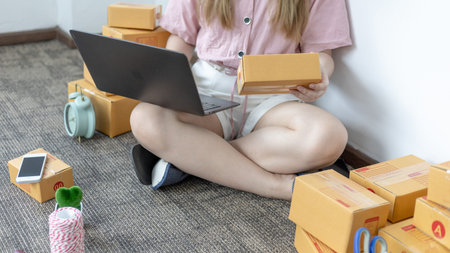 Young woman uses a laptop to chat with customers who come to order product, New young businesses...