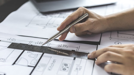 Engineer and Architect concept, Man uses a ruler to measure the floor plan on the blueprint,...
