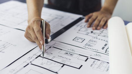 Engineer and Architect concept, Man uses a ruler to measure the floor plan on the blueprint,...