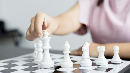 Businesswoman playing chess, Proactive business planning and marketing strategy just like playing chess, Business competition and success, Leadership concept.の写真素材