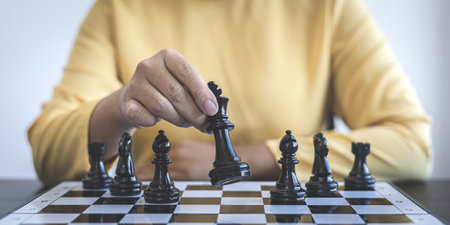 Businesswoman playing chess, Proactive business planning and marketing strategy just like playing chess, Business competition and success, Leadership concept.の写真素材