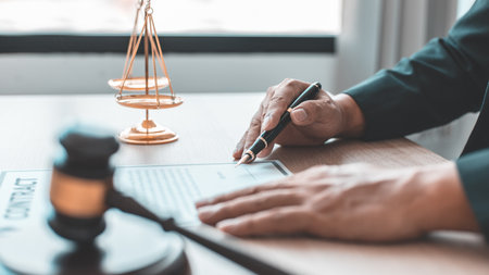 Lawyers or judges sign documents in accordance with legal and fair terms of agreement, Legal Ethics and Integrity, scales of justice, law hammer, Litigation and legal services.の写真素材