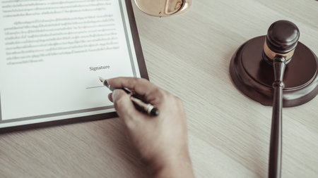 Lawyers or judges sign documents in accordance with legal and fair terms of agreement, Legal Ethics and Integrity, scales of justice, law hammer, Litigation and legal services.の写真素材