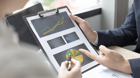 Brainstorm team, Marketers and financial accountants are discussing and analyzing charts to plan...